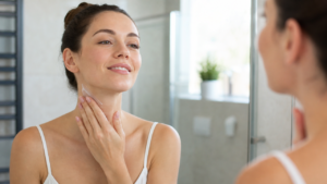 woman applying cream to her neck
