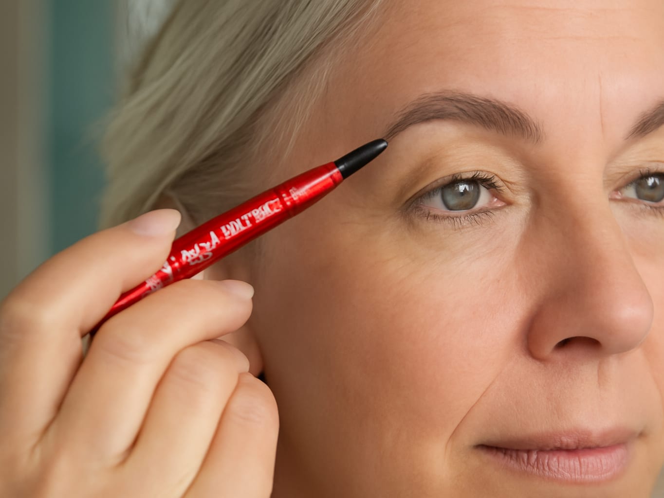 L'Oreal Paris Faux Brow, Hair-Like, Filling Eyebrow Pen, Dark Brunette: A woman in her fifties drawing fine upward brow