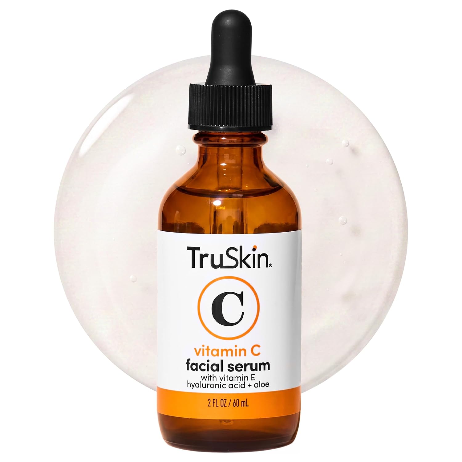 TruSkin Brightening Vitamin C Serum for Face with Hyaluronic Acid, 2 fl oz: A woman applying a drop of clear vitamin C s